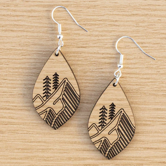 Laser engraved earrings shaped like a leaf with engraved images of mountains and trees. Made with Oak Truflat wood sold by Thunder Laser Canada. Canada Laser Supply