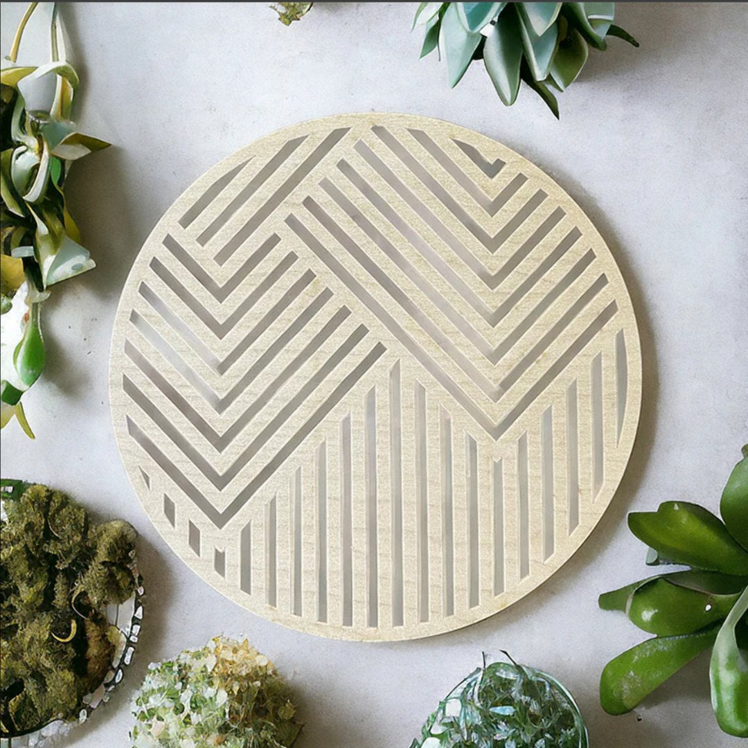 A circle of Maple Truflat wood laser cut with designs to make stripes diagonally.