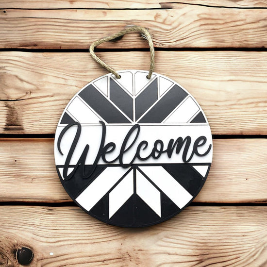 a black and white circular welcome sign made on a laser cutter using Truflat engineered wood sold by Thunder Laser Supply Canada