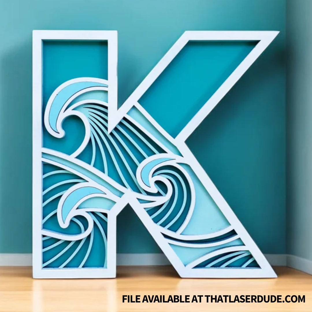 Example of TruFlat Paint primed plywood laser project- the letter K with vibrant blue tones in ocean waves inside the letter