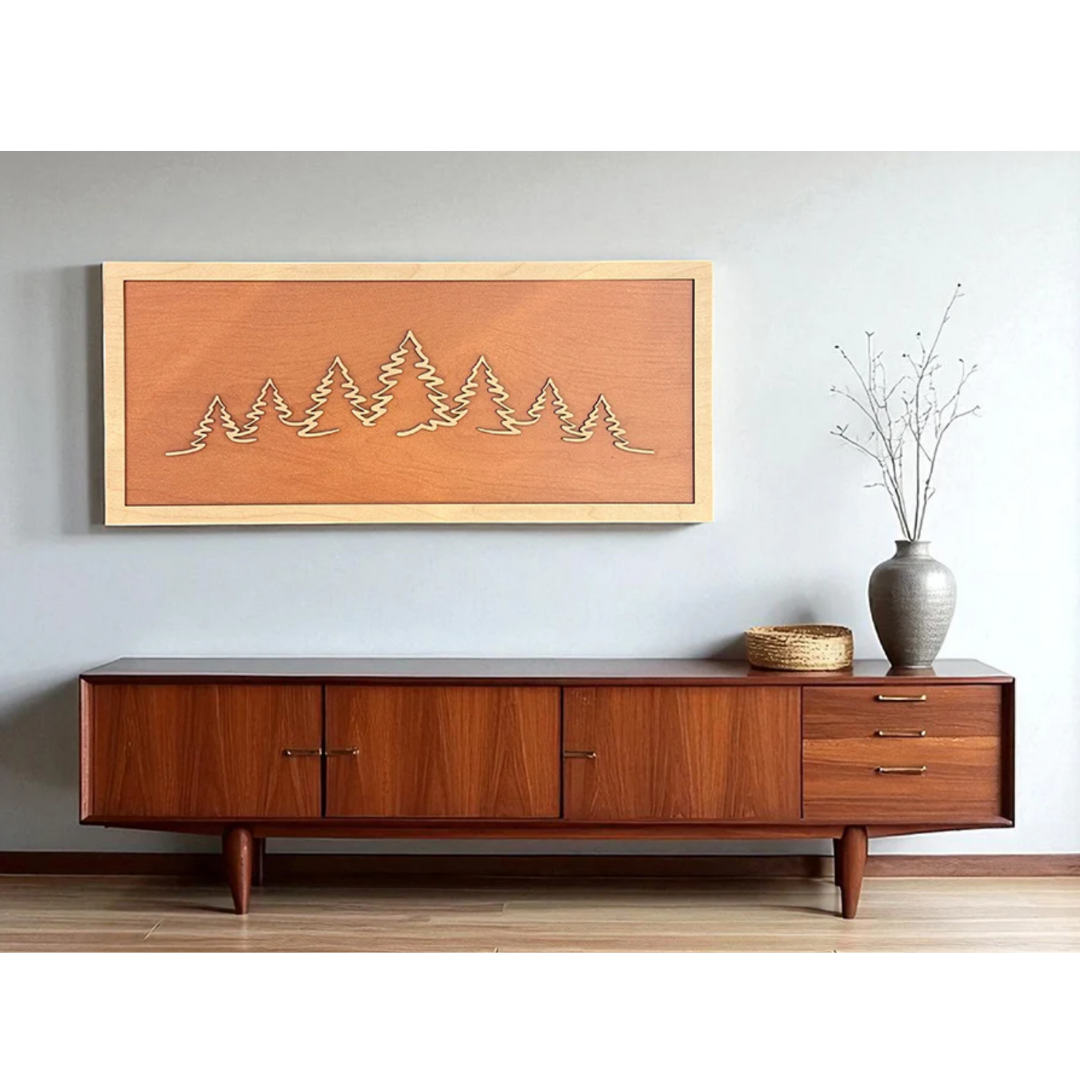 Wooden sideboard with decorative mountain art above it in a room. Made from Truflat cherry laser plywood sold by Thunder Laser Canada